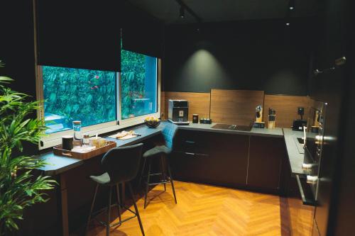 a kitchen with a counter and stools in it at Villa37 - Maison privée indépendante centre-ville Limoges in Limoges