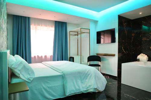 a bedroom with a white bed and a bathroom at Hotel Max in Aversa