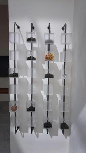a display case with four shelves with food on it at 沐正農場 木一館 嘉義包棟民宿 in Zhongpu