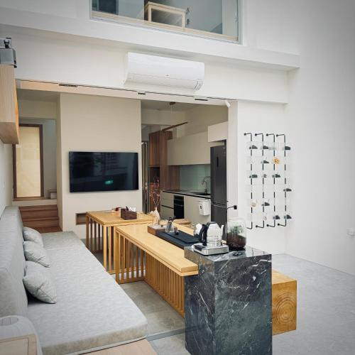 a living room with a couch and a table at 沐正農場 木一館 嘉義包棟民宿 in Zhongpu
