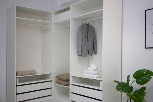 a white walk in closet with white cabinets at SingularStays Tinglado in Valencia