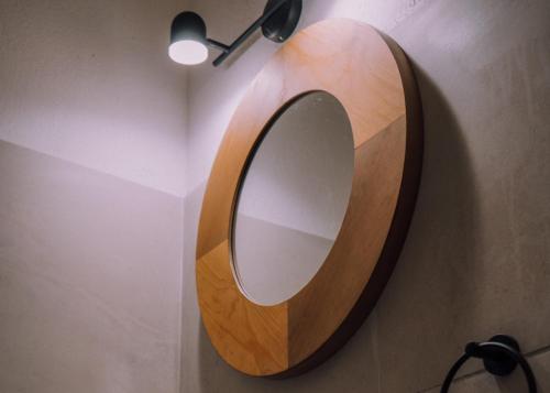 a wooden mirror on a wall with a lamp at Hotel Pimampiro in Puerto Baquerizo Moreno