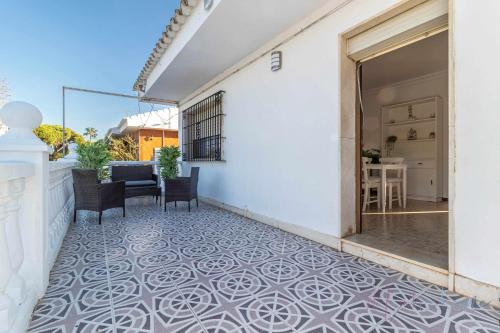 a balcony with a tile floor on a white building at Chalet a pie de playa in Punta Umbría