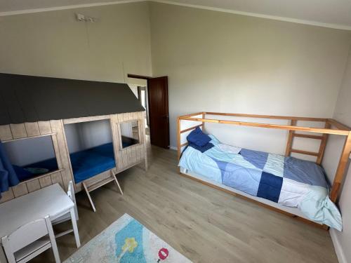 a bedroom with two bunk beds and a table at Villa Terre d'Albion in Albion