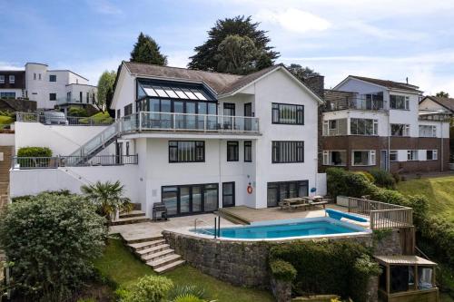 a large white house with a swimming pool at Stunning Property Seaviews, Private Pool & Parking in Saundersfoot