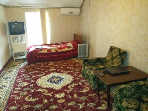 a living room with a couch and a table at Sayfi Guesthouse in Dushanbe