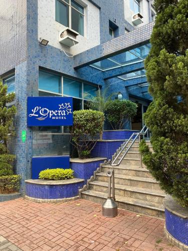 a building with stairs and a sign on it at L'Opera Hotel in Sao Paulo