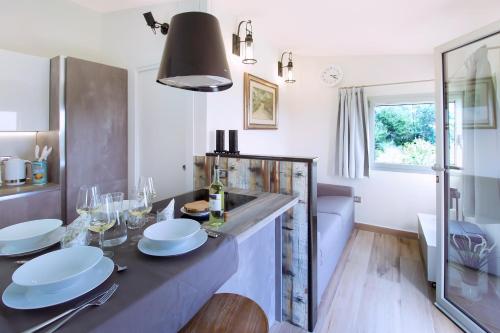 a kitchen with a counter with white dishes on it at Villa Magdala in La Maddalena