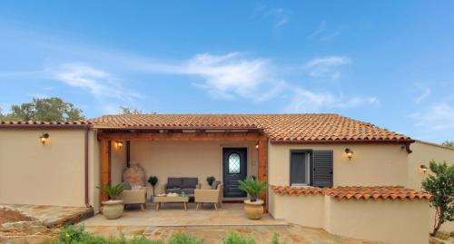 a house with a patio in front of it at Villa Magdala in La Maddalena