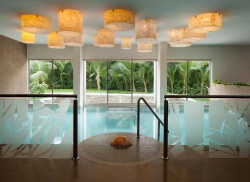 a house with a swimming pool with lights at El Dorado Seaside Suites Oceanfront, Catamarán, Ecoturistic Ranch, All & More Inclusive - Adults Only in Akumal