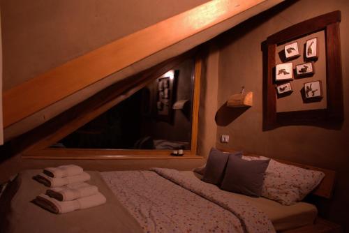 a bedroom with a bed with a large mirror at Šumska 1 - Fruška gora in Sremska Kamenica
