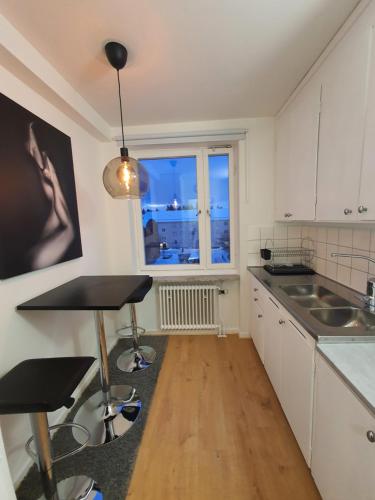 a kitchen with a table and a window with a view at Close to the subway. Beautiful and Cozy apartment! in Stockholm