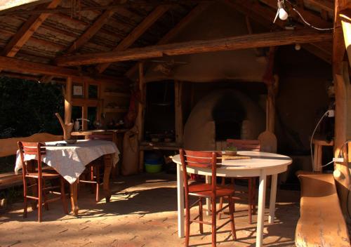 a table and chairs in a room with a fireplace at Šumska 1 - Fruška gora in Sremska Kamenica