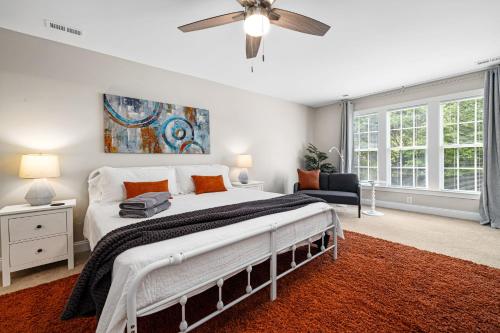 a bedroom with a bed and a ceiling fan at The Junction House - Near Downtown Cary & RDU in Cary