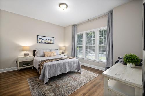 a bedroom with a bed and a window at The Junction House - Near Downtown Cary & RDU in Cary