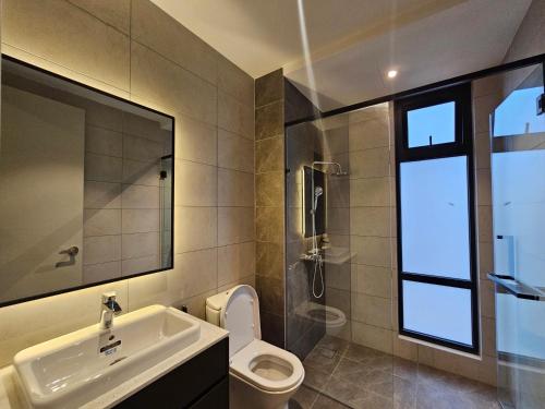 a bathroom with a sink and a toilet and a mirror at The Axon Residence Bukit Bintang in Kuala Lumpur