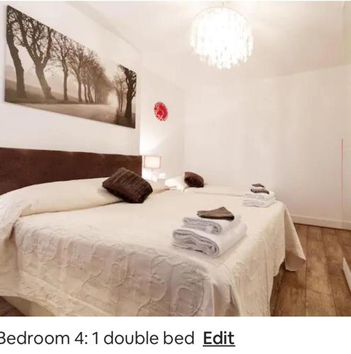 a bedroom with a bed with towels on it at 4 Bed Flat - Sleeps 14 - Parking - Game Room -Wifi in London