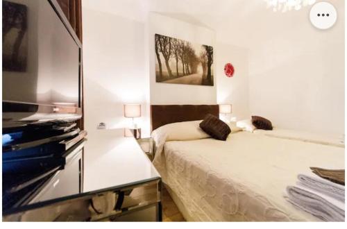 a bedroom with a bed and a painting on the wall at Super large apartment in London for larger groups in London