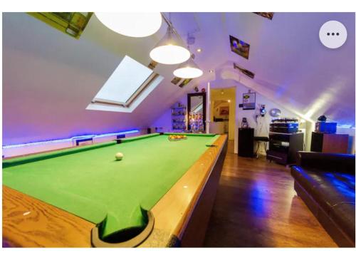 a living room with a pool table in it at 4 Bed Flat - Sleeps 14 - Parking - Game Room -Wifi in London