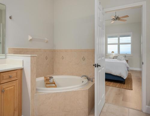 a bathroom with a bath tub and a bed at 365 Cinnamon Beach in Palm Coast