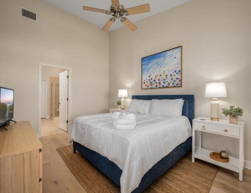 a bedroom with a large bed with a ceiling fan at 365 Cinnamon Beach in Palm Coast