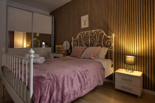 a bedroom with a large bed with a white bed frame at NiceApart near Old Town in Wrocław