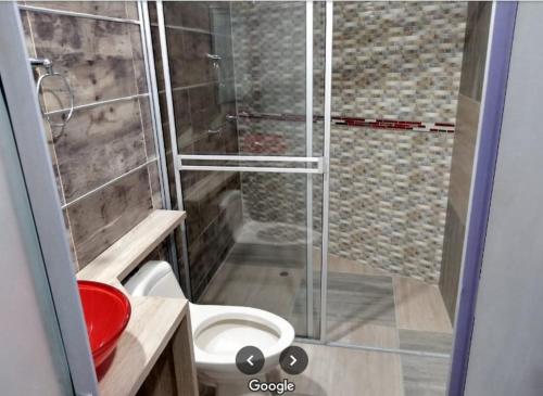 a bathroom with a toilet and a glass shower at Hotel Sharey 