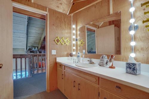 a bathroom with a sink and a mirror at Red Feather Lakes Cabin with Deck and Views! in Red Feather Lakes
