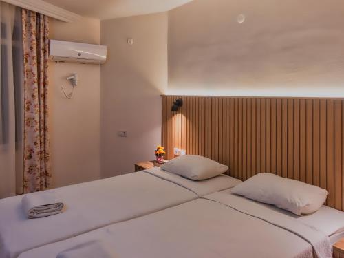 a bedroom with two white beds and a window at Bella Rose Apart Hotel, Renovated in 2023! in Alanya