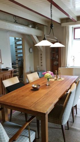 una gran mesa de madera en la sala de estar. en Oude woonboederij/old farmers house/typ. NL-Bauernhaus, en Zeddam