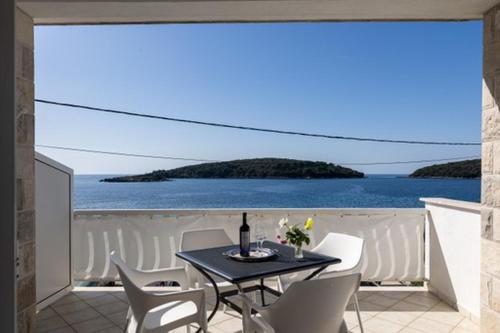 a dining room with a view of the ocean at House Rasica in Molunat