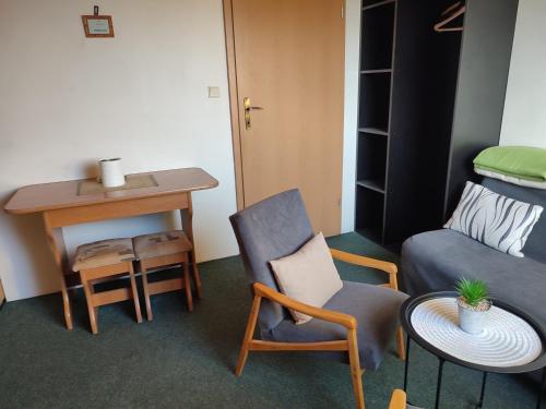 a room with a couch and a table and a chair at Privat Mária in Liptovský Ján