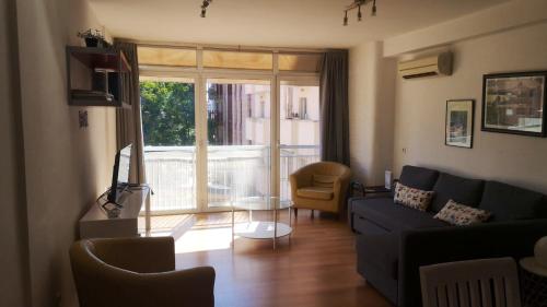 a living room with a couch and a table at 3 bedrooms appartement with wifi at Valencia 3 km away from the beach in Valencia
