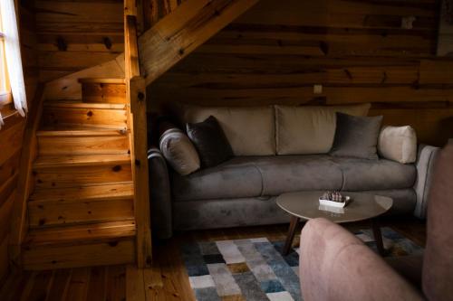 a living room with a couch and a table at Rajska koliba in Kaludjerske Bare