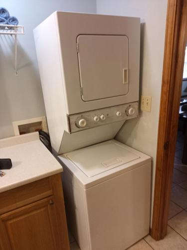 a washer and dryer in a kitchen next to a counter at Oakhaven Annex in Long Beach