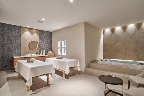 a bathroom with two tables and a bath tub at Borgo Lanciano in Castelraimondo
