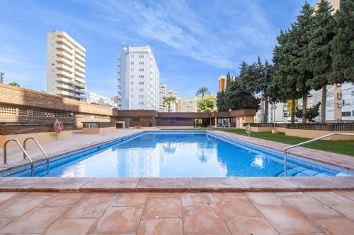 a large swimming pool in the middle of a city at Los Pinos 9B Apartment Levante Beach-Old Town in Benidorm