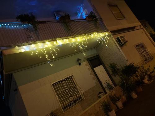 a string of lights on the side of a building at B&B Petra Hercules in Torre Annunziata