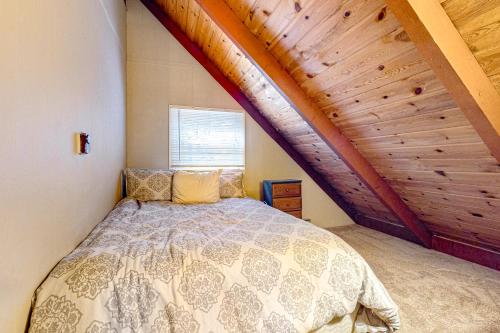 a bedroom with a bed and a wooden ceiling at Crescent Corner in Waterboro