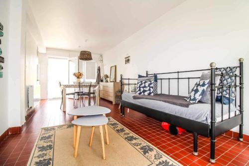 a bedroom with a bed and a table and a chair at Ste Cécile Plage in Camiers