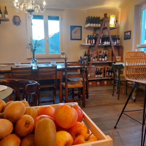 a room with a table and a bowl of fruit at Agriturismo Tenuta La Fratta in Bagni di Lucca