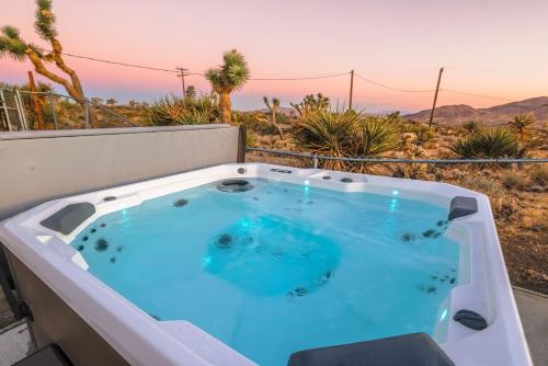 a hot tub on a balcony with a view at New: Dome, Hot Tub, Game Room, 5 min to park in Joshua Tree