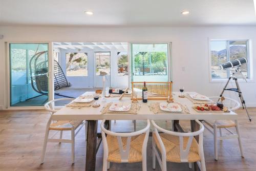 a dining room with a table with chairs and a camera at New: Dome, Hot Tub, Game Room, 5 min to park in Joshua Tree