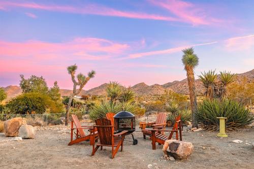a group of chairs and a grill in the desert at New: Dome, Hot Tub, Game Room, 5 min to park in Joshua Tree