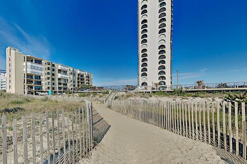 a beach with a fence and a tall building at 9400 Bldg #401 in Ocean City