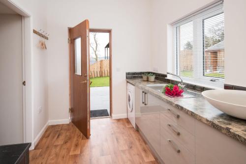 a kitchen with a sink and a counter with a window at Byre in Melrose