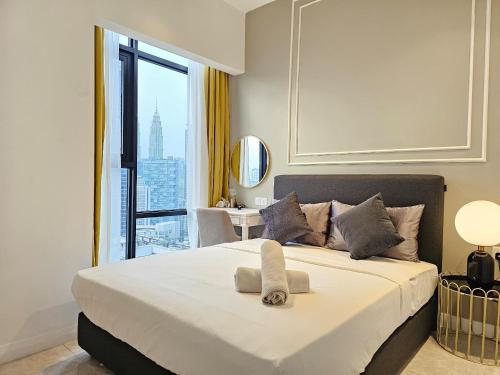 a bedroom with a large bed with a large window at The Axon Residence Bukit Bintang in Kuala Lumpur