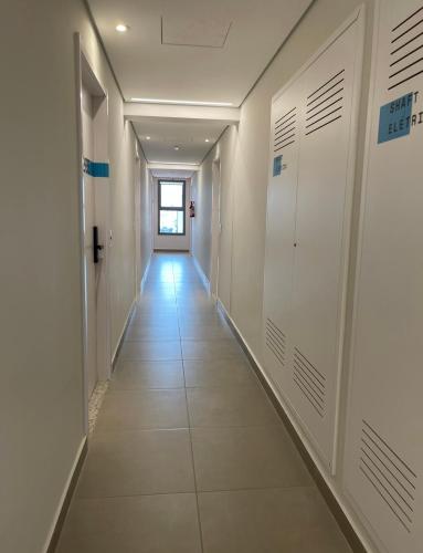 a corridor in a hospital with white walls and tile floors at Studio aeroporto Congonhas in Sao Paulo