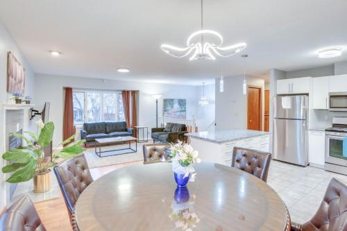 a kitchen and living room with a table and chairs at Lovely Minneapolis Home Near Target Field! in Minneapolis