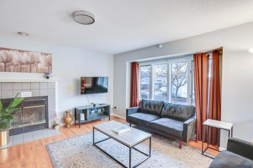 a living room with a couch and a fireplace at Lovely Minneapolis Home Near Target Field! in Minneapolis